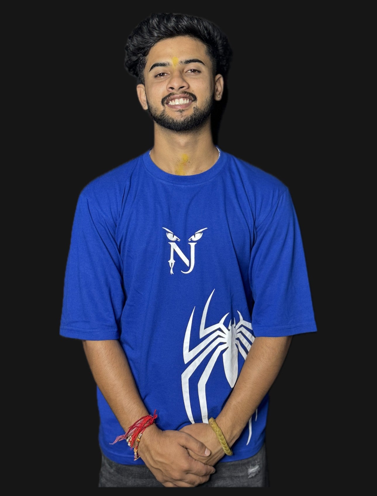 Person wearing a blue t-shirt with a logo on a black background
