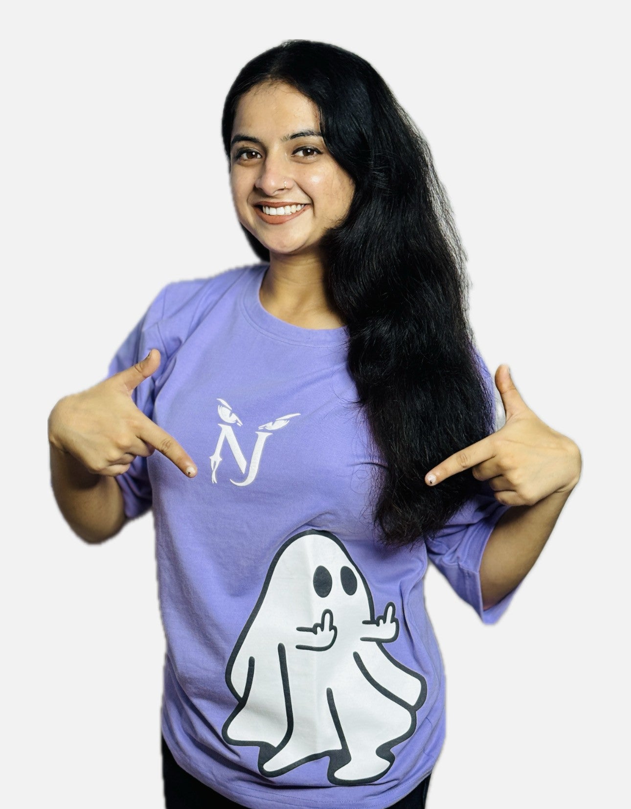 Woman wearing a purple shirt with a ghost graphic and pointing to it, on a white background