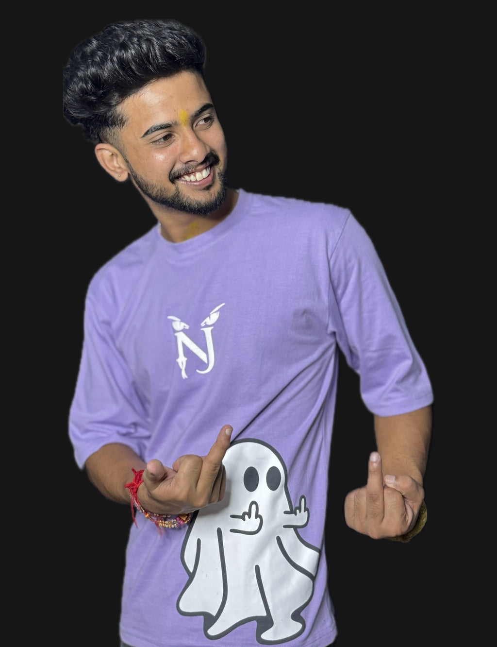 Person wearing a purple t-shirt with a ghost graphic and logo on a black background