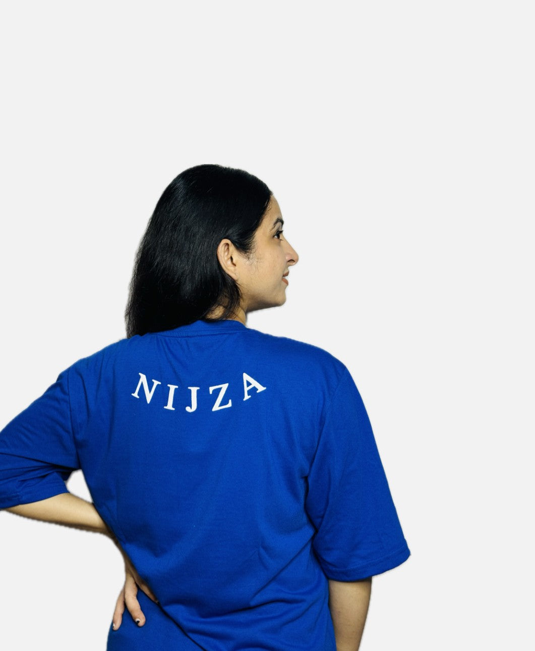 Person wearing a blue t-shirt with 'NIJZA' printed on the back against a white background