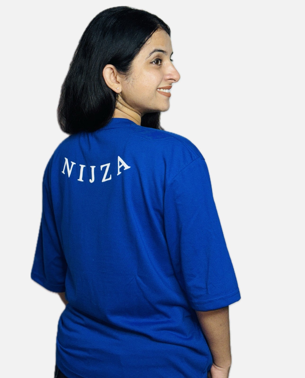 Person wearing a blue t-shirt with 'Nijza' printed on the back against a white background