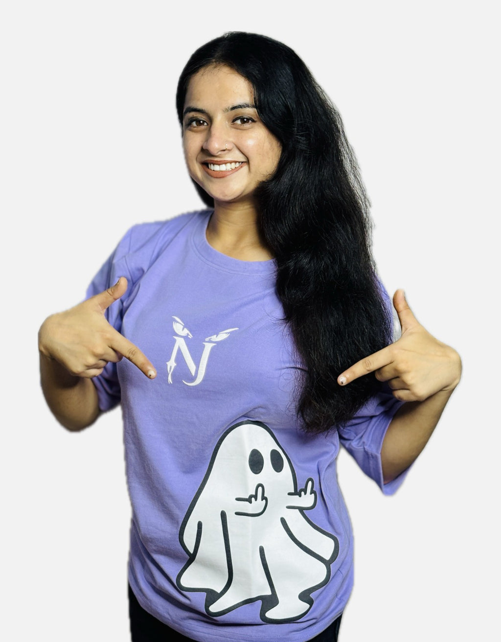 Woman wearing a purple shirt with a ghost graphic and pointing to it, on a white background